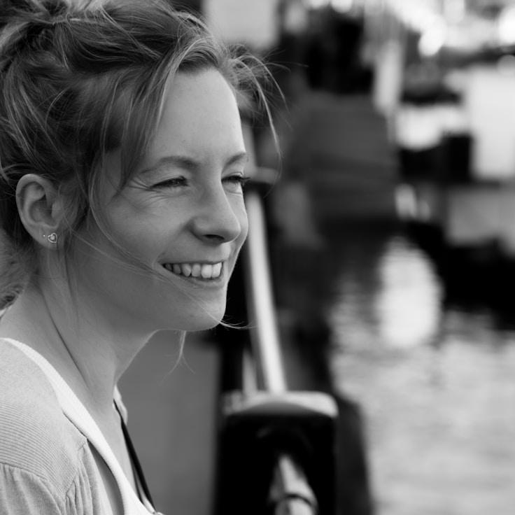 Ava Singh, Lead Design Curator at Quiet River Connection, reviewing corporate floral arrangements